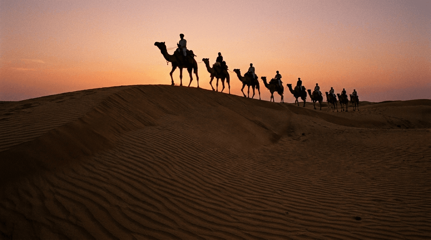 A camel caravan silhouetted on the Sam sand dunes near Jaisalmer at sunset
